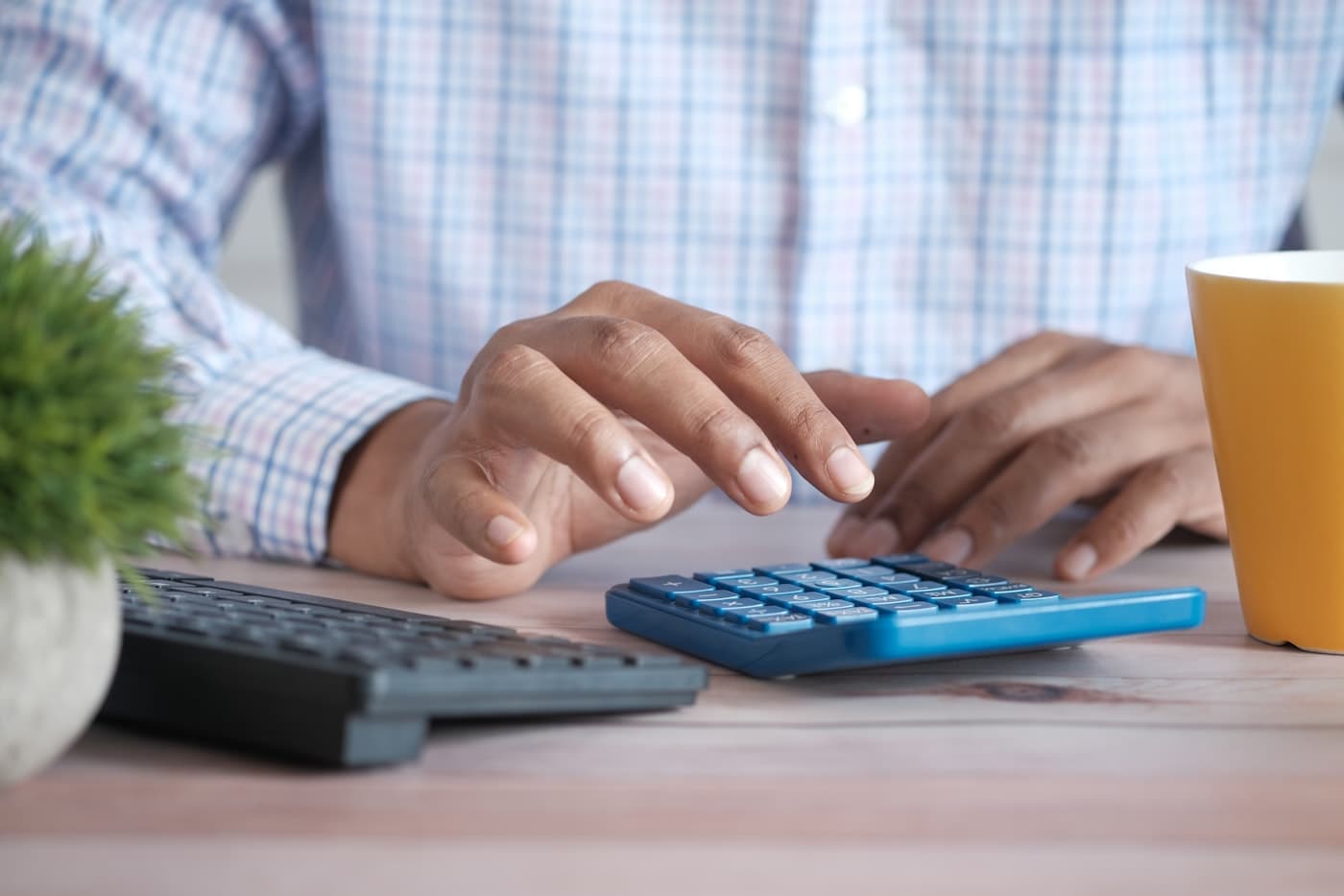 Persona haciendo cuentas de su negocio con una calculadora